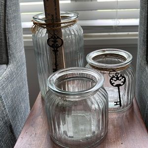 Three ribbed glass  jars/vases with key accents